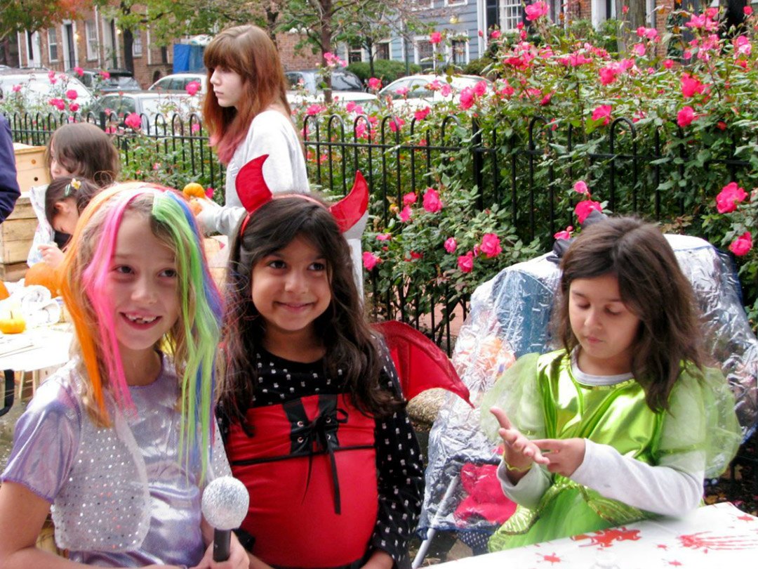 Friends of Rose Park - children in costume & rose bushes along fence