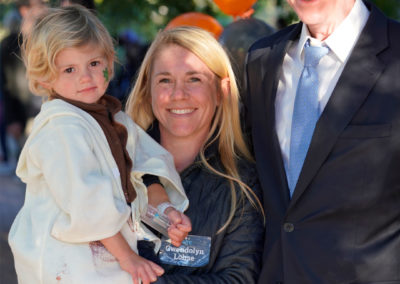 Friends of Rose Park - Halloween 2018 - photo with man and a woman holding a child - close up alternate pose
