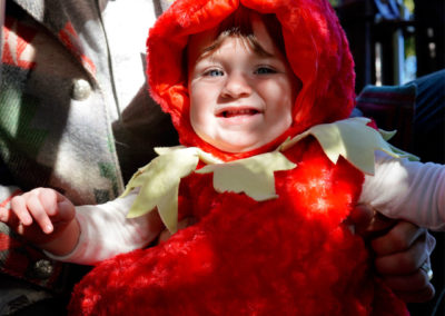 Friends of Rose Park - Halloween 2018 - man holding a child dressed as a strawberry