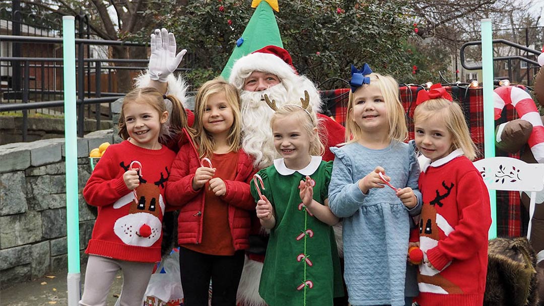 Children lined up for photo in front of Santa